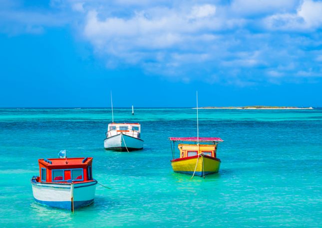 Aruba - coloured boat in amazing blue water