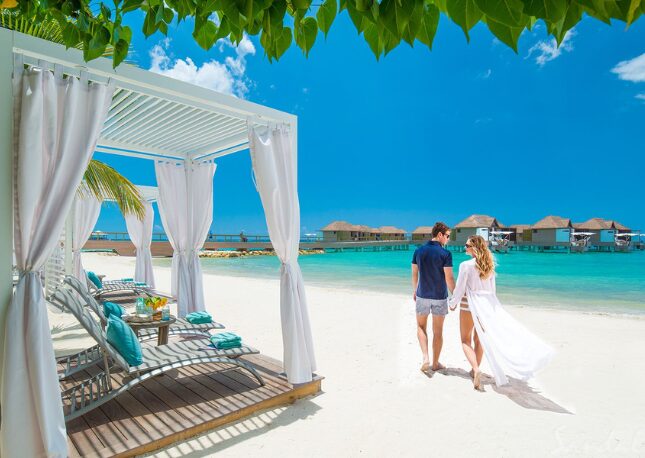 Couple strolling the beach at Sandals South Coast