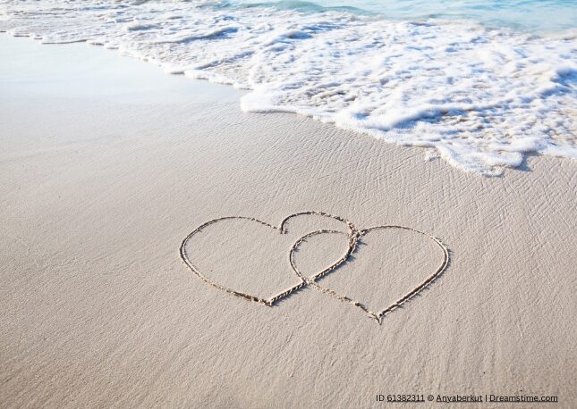Hearts in the sand for a destination wedding.
