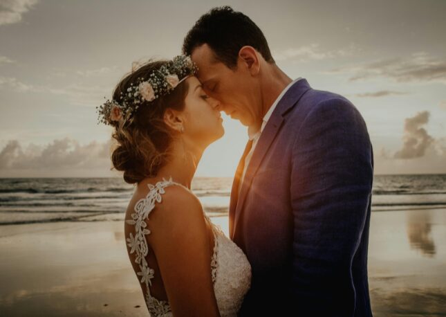 Couple enjoying a well deserved moment during sunset on their wedding day.