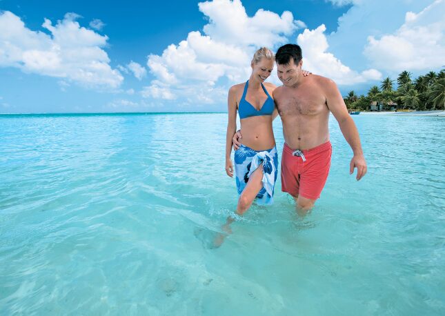 Walking in crystal clear waters of Tahiti